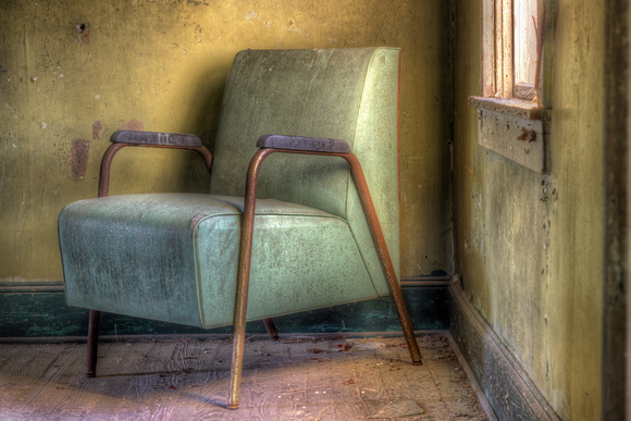 A Green Chair and A Yellow Wall